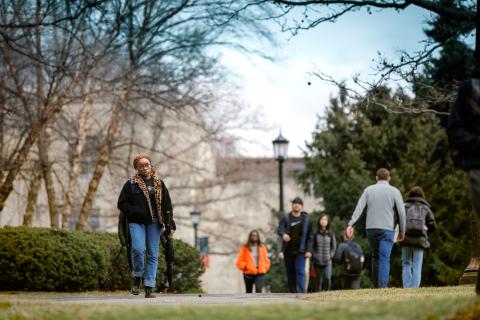 students walk across campus in early spring
